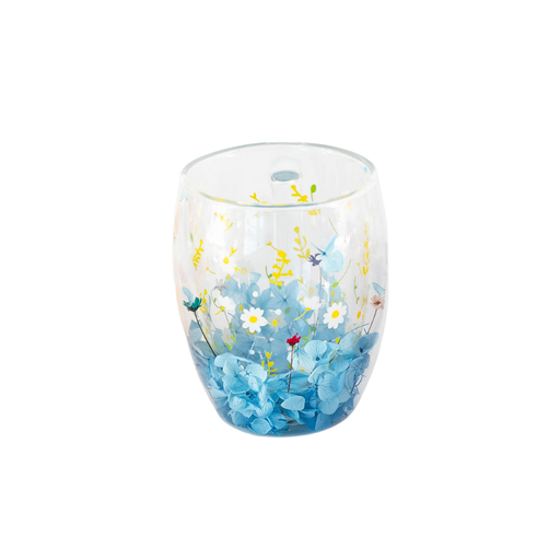 Clear glass tumbler with floral design on a white background