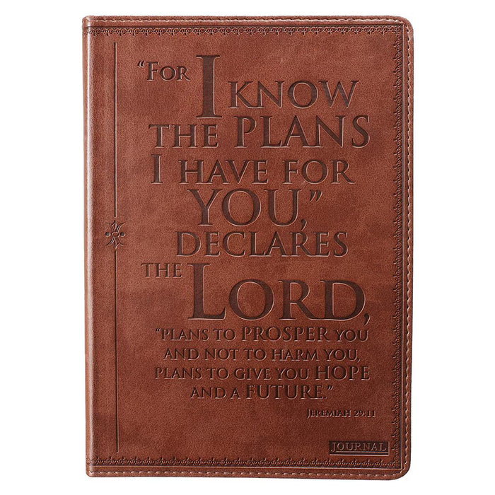 Brown leather journal with embossed text on a white background