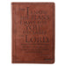 Brown leather journal with embossed text on a white background