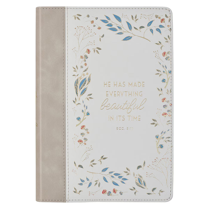 Journal with floral design and inspirational quote on a white background