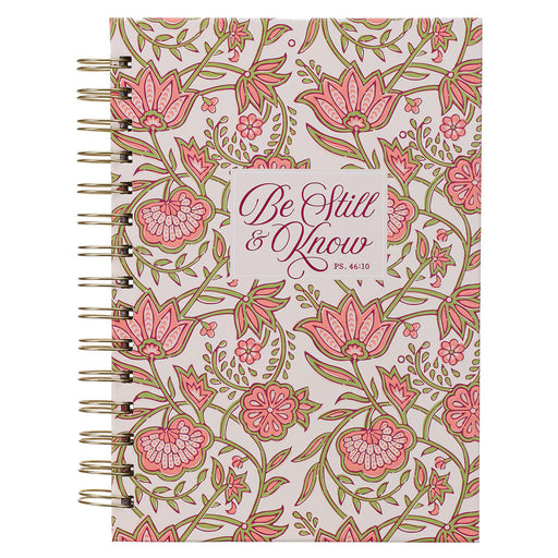 Notebook with floral design and 'Be Still & Know' text on a white background