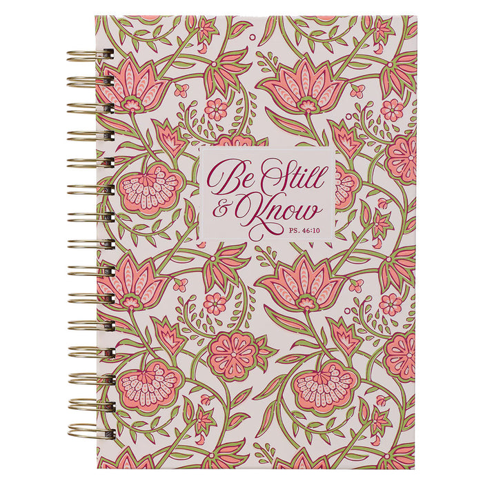 Notebook with floral design and 'Be Still & Know' text on a white background