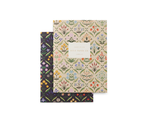 Two floral-patterned notebooks on a white background