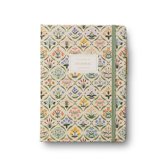 Floral patterned journal with a green ribbon on a white background