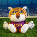 Plush tiger toy with LSU logo on grass in stadium setting