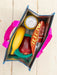 Reusable shopping bag with a banana, apple, can of soda, and bottle of hot sauce on a wooden surface.