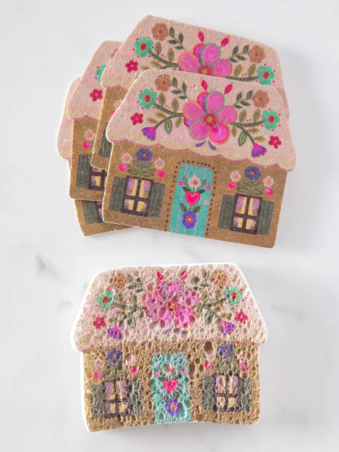 Decorative house-shaped coasters with floral designs on a white background