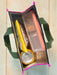 Small pouch with a yellow tool, can, and other items on a wooden surface