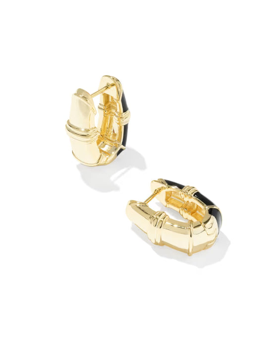 A pair of gold huggie hoop earrings with black enamel inlay, shown from different angles on a clean white background.