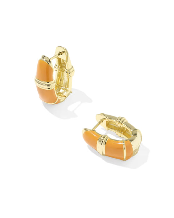 A pair of gold hoop earrings with curved orange enamel inlays, displayed on a clean white background.