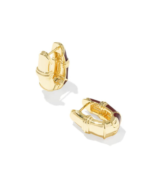 A pair of gold huggie hoop earrings with a bamboo-inspired segmented design and dark brown enamel accents, shown on a clean white background.
