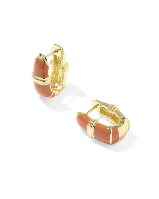 A pair of gold hoop earrings with curved terracotta orange enamel inlays, displayed on a clean white background with soft shadows.