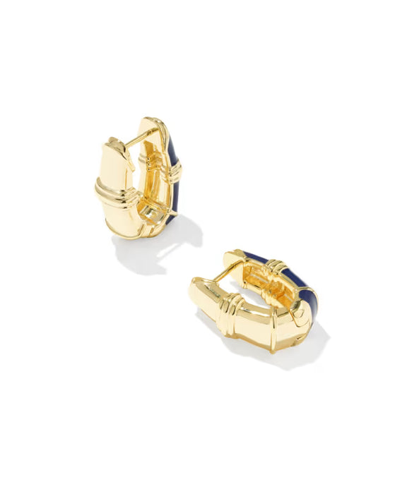 A pair of gold huggie hoop earrings with dark blue enamel inlay, shown on a clean white background.