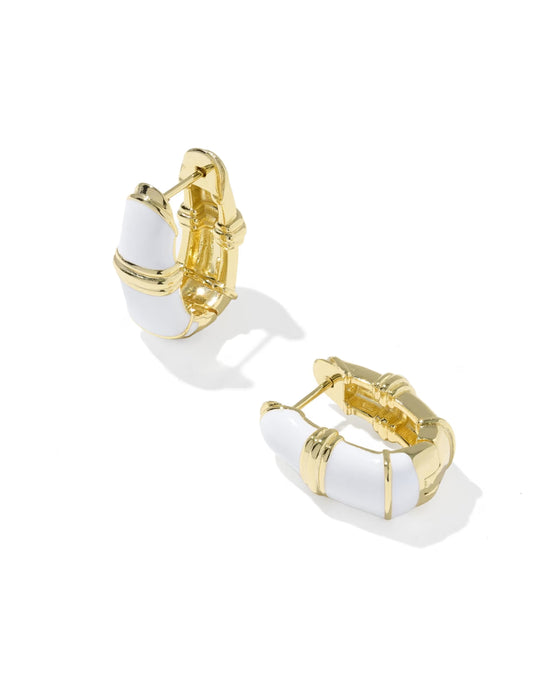 A pair of gold huggie hoop earrings with white enamel inlay, shown on a clean white background.