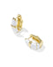 A pair of gold huggie hoop earrings with white enamel inlay, shown on a clean white background.