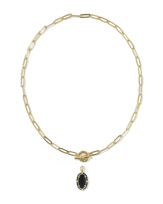 A gold paperclip chain necklace with a toggle clasp and a small oval black onyx pendant, shown on a plain white background.
