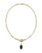 A gold paperclip chain necklace with a toggle clasp and a small oval black onyx pendant, shown on a plain white background.