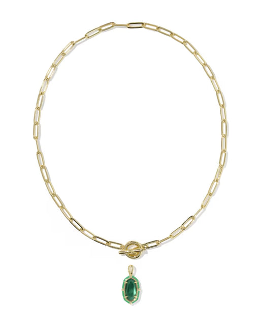 A gold paperclip chain necklace with a toggle clasp and a small oval green gemstone pendant, shown on a plain white background.