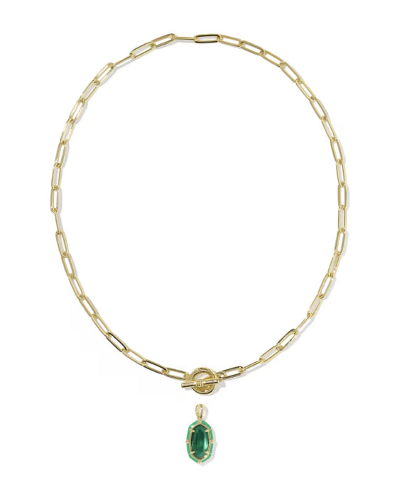 A gold paperclip chain necklace with a toggle clasp and a small oval green gemstone pendant, shown on a plain white background.