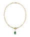 A gold paperclip chain necklace with a toggle clasp and a small oval green gemstone pendant, shown on a plain white background.