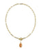 A gold paperclip chain necklace with a toggle clasp and a dangling oval amber gemstone pendant, shown on a plain white background.