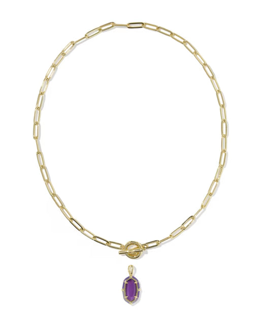 A gold paperclip chain necklace with a toggle clasp and a small oval purple gemstone pendant, shown on a plain white background.