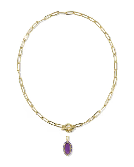 A gold paperclip chain necklace with a toggle clasp and a small oval purple gemstone pendant, shown on a plain white background.
