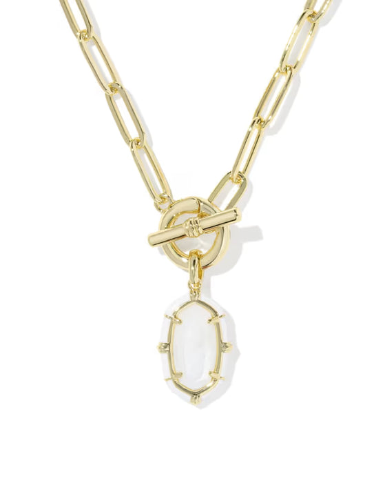 A gold paperclip chain necklace with a toggle clasp and a dangling oval white stone pendant, shown on a clean white background.