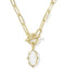 A gold paperclip chain necklace with a toggle clasp and a dangling oval white stone pendant, shown on a clean white background.