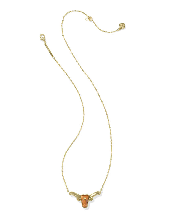 A delicate gold chain necklace featuring a small, stylized longhorn pendant with a textured orange center, displayed on a clean white background.