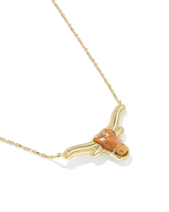 A gold chain necklace with a pendant shaped like a longhorn steer head, featuring a textured orange stone and small clear crystals, shown on a white background.