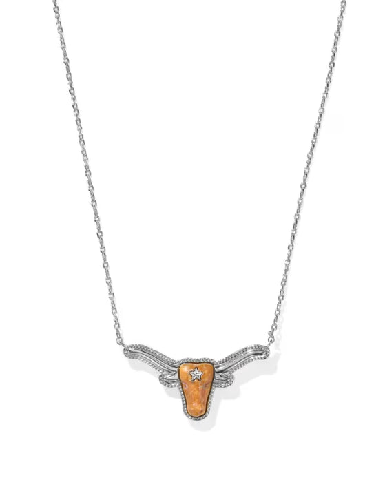 A silver-toned necklace featuring a longhorn-shaped pendant with a textured orange center and a small clear gemstone, shown on a plain white background.