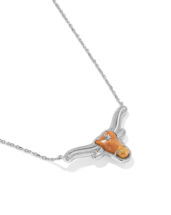 A silver-toned necklace featuring a longhorn pendant with a textured orange stone and a small clear gemstone, shown on a white background.