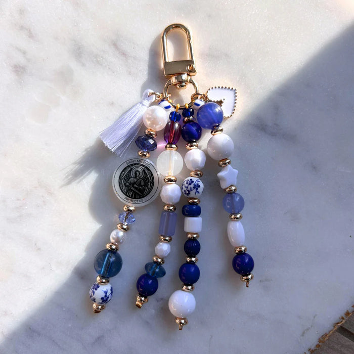 Decorative keychain with beads and tassel on a marble surface