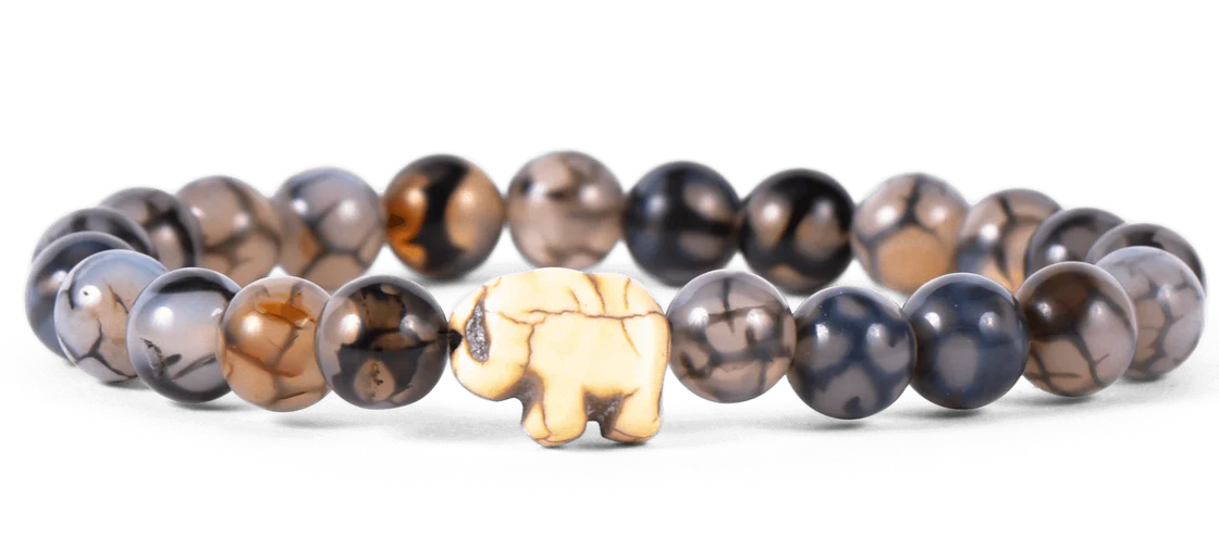 Bracelet with beaded design and a small elephant charm on a white background