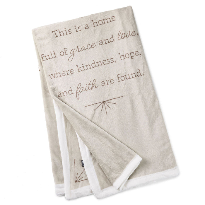 Folded blanket with inspirational text on a white background