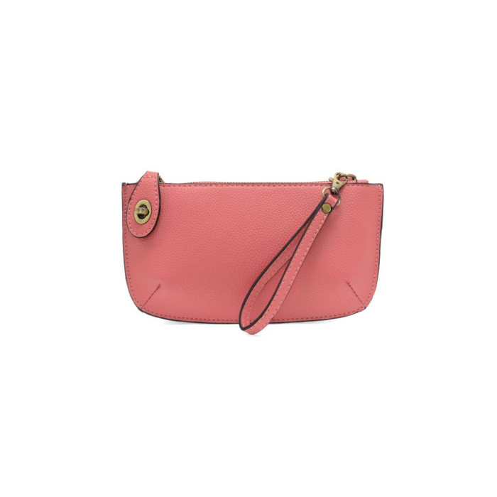 Pink wristlet purse with a strap on a white background