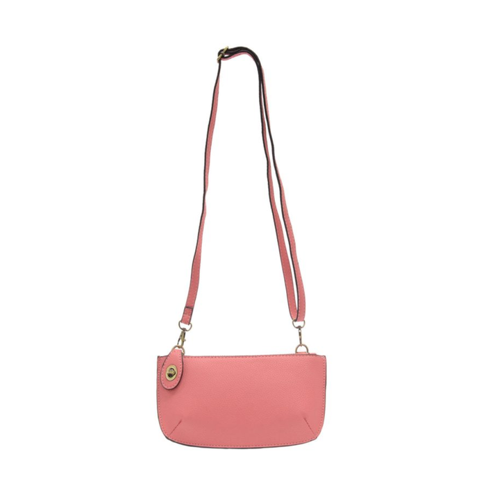 Pink crossbody bag with a strap on a white background