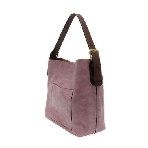 Purple handbag with brown strap and buckle on a white background