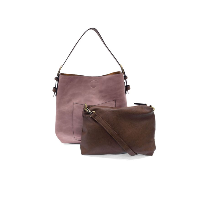Two leather handbags, one pink and one brown, on a white background.