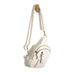 White crossbody bag with gold accents on a white background