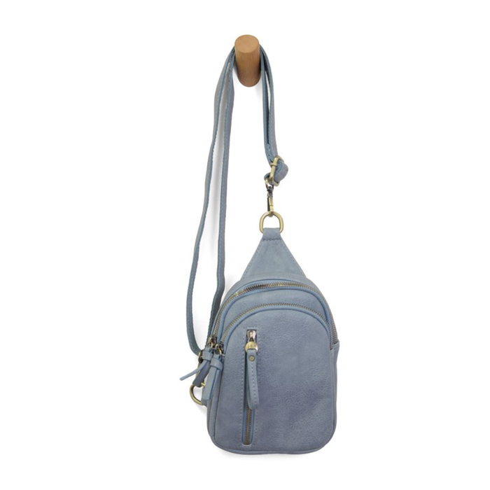 Light blue crossbody bag with a strap on a white background