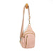 Pink crossbody bag with gold zippers on a white background