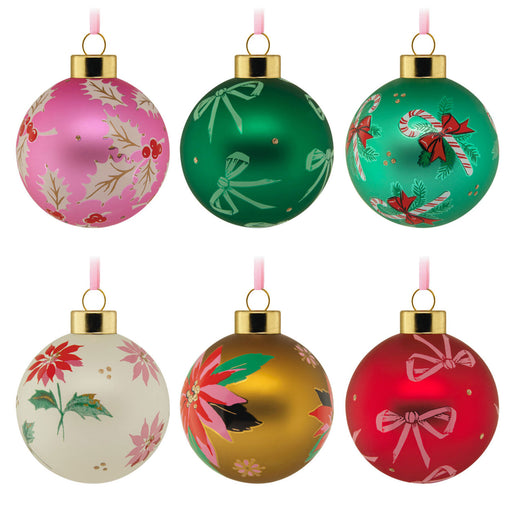 Set of six colorful Christmas ornaments with floral and candy cane designs on a white background.