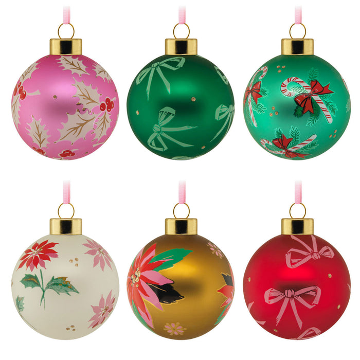 Set of six colorful Christmas ornaments with floral and candy cane designs on a white background.