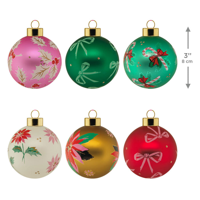 Set of six colorful Christmas ornaments with floral and candy cane designs on a white background.