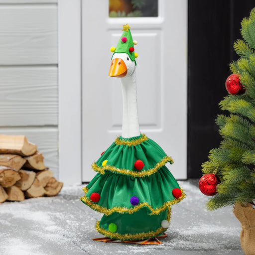 Decorative goose in a Christmas tree costume with a festive hat and ornaments, standing outdoors.