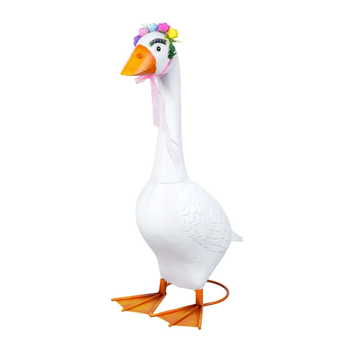 A white goose-shaped decorative figure or costume with an orange beak and orange webbed feet, a pink ribbon around the neck, and a small multicolor flower crown, isolated on a white background.