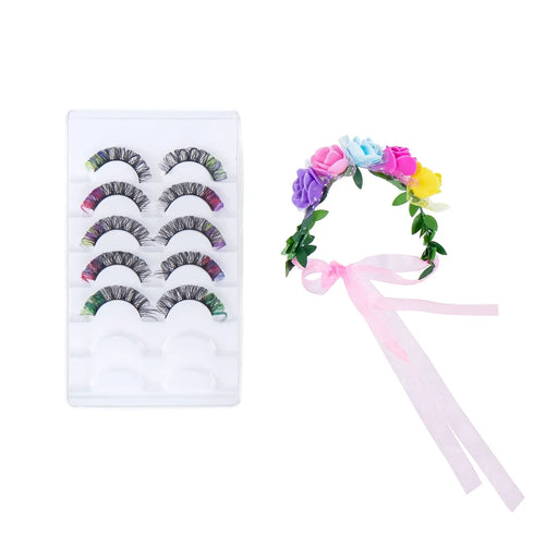 A pair of false eyelashes with a black and white wavy pattern, shown alongside a small rainbow-themed applicator wand on a plain white background.