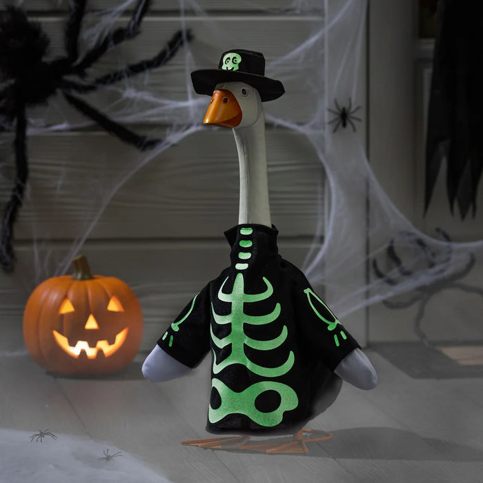 Goose wearing a Halloween skeleton costume with a pumpkin and spider webs in the background
